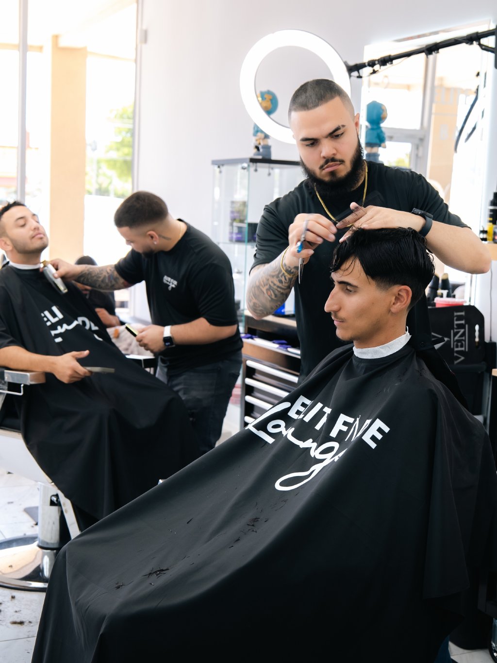 Barbers at work inside Elite Fade Lounge